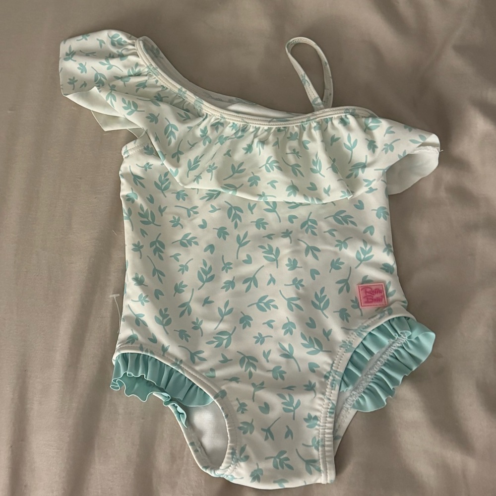 Ruffle Butts Floral One-Shoulder Swimsuit baby girl toddler cream white print
